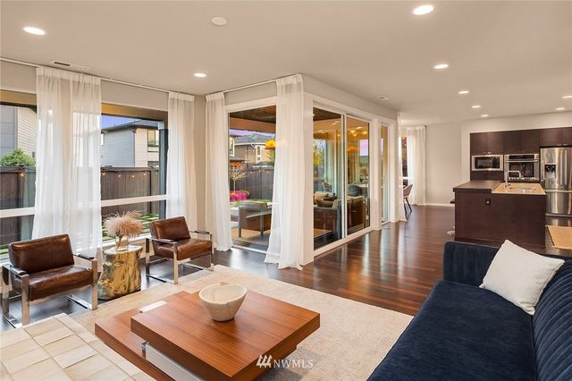 a kitchen with a table chairs sink and cabinets