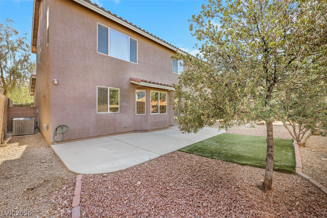 10328 Hawk Ravine Street Las Vegas, NV 89178 - Photo 48 of 55 A spacious backyard patio seamlessly blends with low-maintenance desert landscaping.