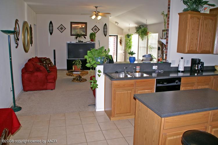 4710 Capulin Lane Amarillo, TX 79110 - Photo 18 of 18 a kitchen with granite countertop a sink a stove and cabinets
