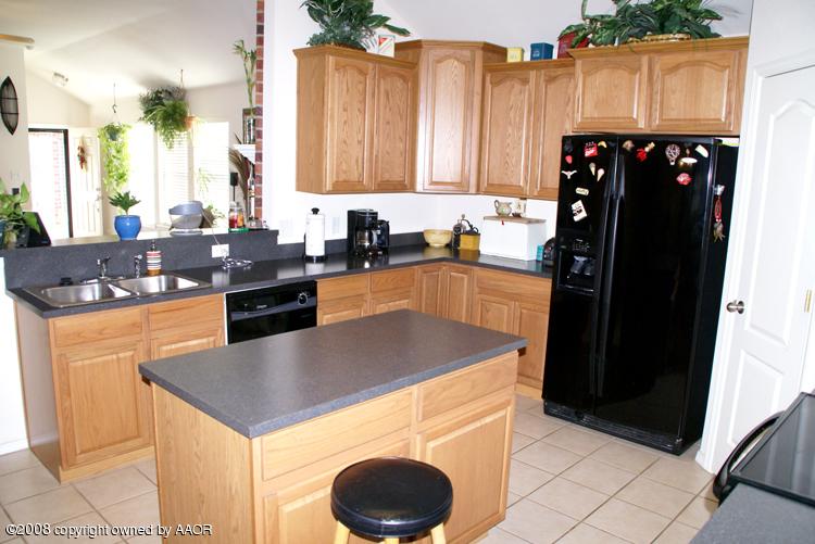 4710 Capulin Lane Amarillo, TX 79110 - Photo 9 of 18 a kitchen with a sink a stove and refrigerator