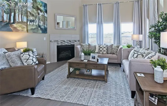 a living room with furniture dining table and a fireplace