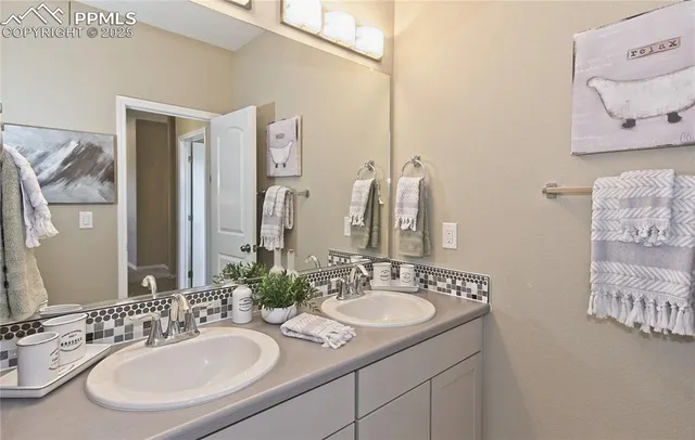 a bathroom with a double vanity sink and a mirror