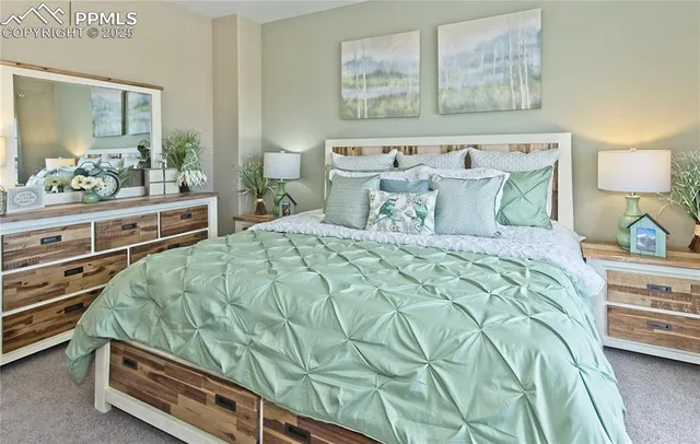 a spacious bedroom with a bed and a dresser in it