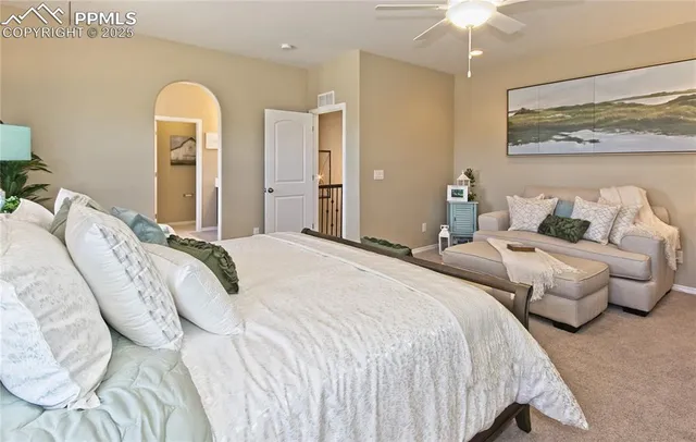 a bedroom with a bed and a chandelier