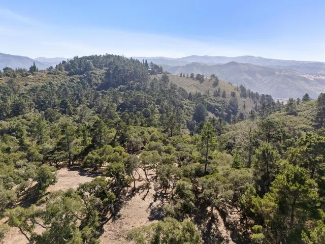a view of a house with a mountain and mountains in the background