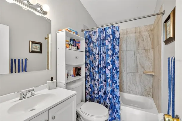 a bathroom with a toilet sink and shower