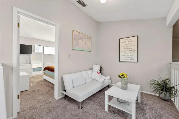 a living room with furniture and next to a window