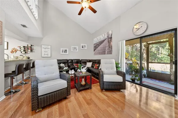 a living room with furniture and wooden floor