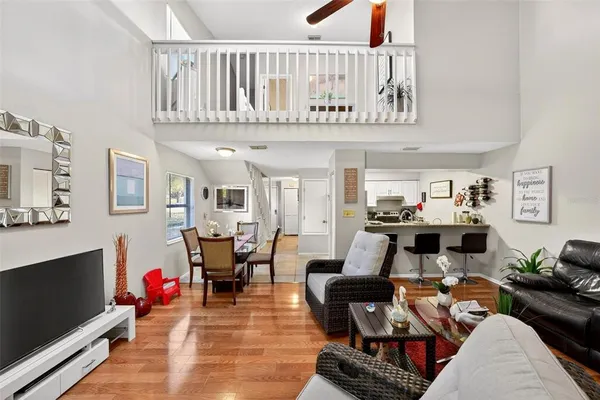 a living room with furniture a rug and a window