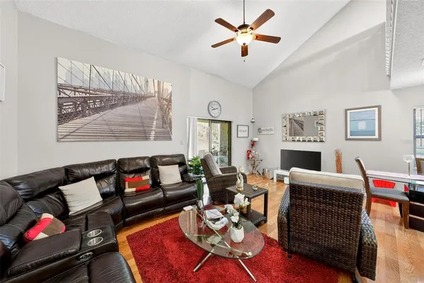 a living room with furniture a rug and white walls