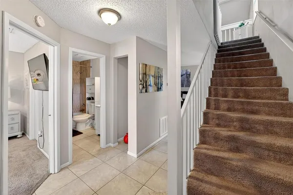 a view of a livingroom with stairs and furniture