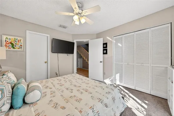a bedroom with a bed dresser and a window