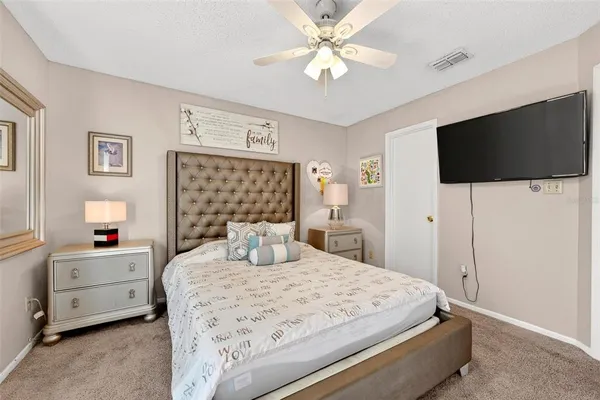 a bedroom with a bed and a flat screen tv