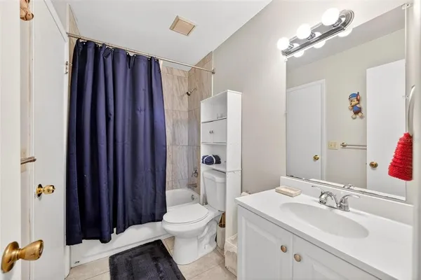 a bathroom with a sink vanity granite toilet and shower