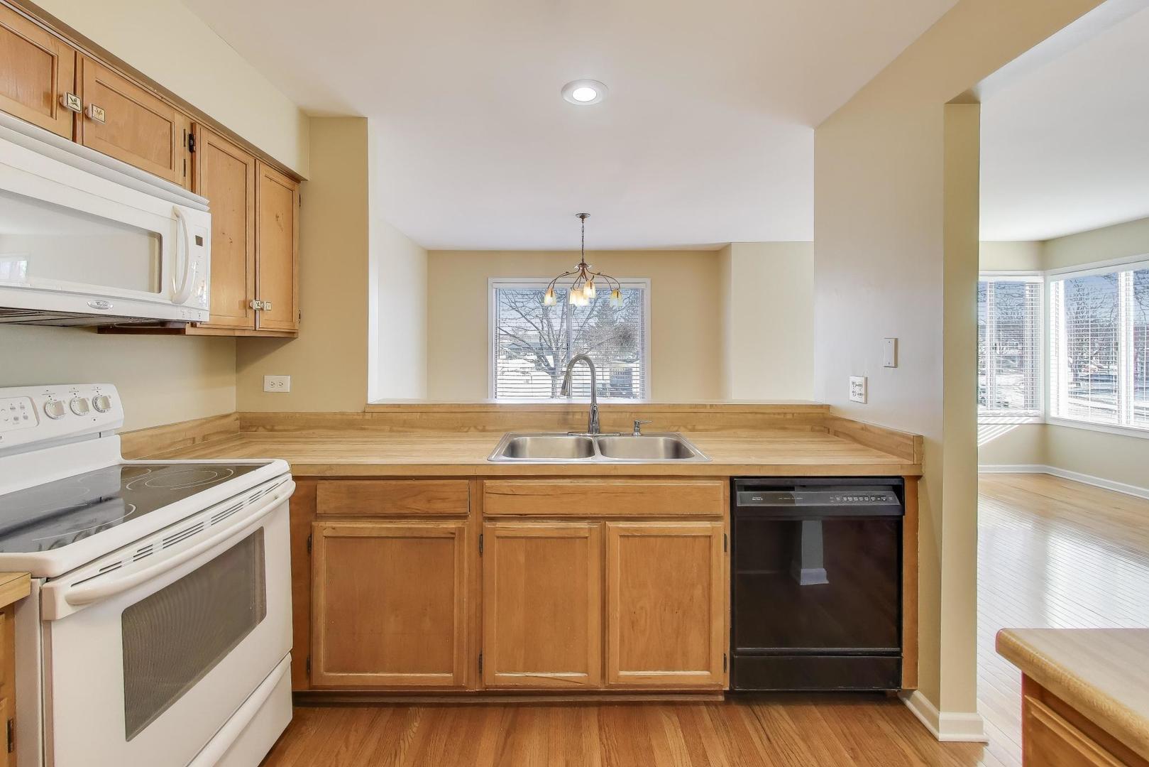 N700 Concord Lane Winfield, IL 60190 - Photo 11 of 31 a kitchen with a sink stove and cabinets