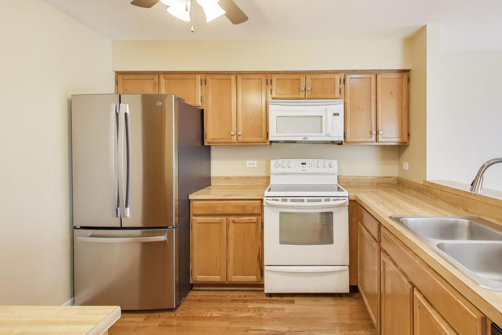 N700 Concord Lane Winfield, IL 60190 - Photo 12 of 31 a kitchen with a refrigerator sink and microwave