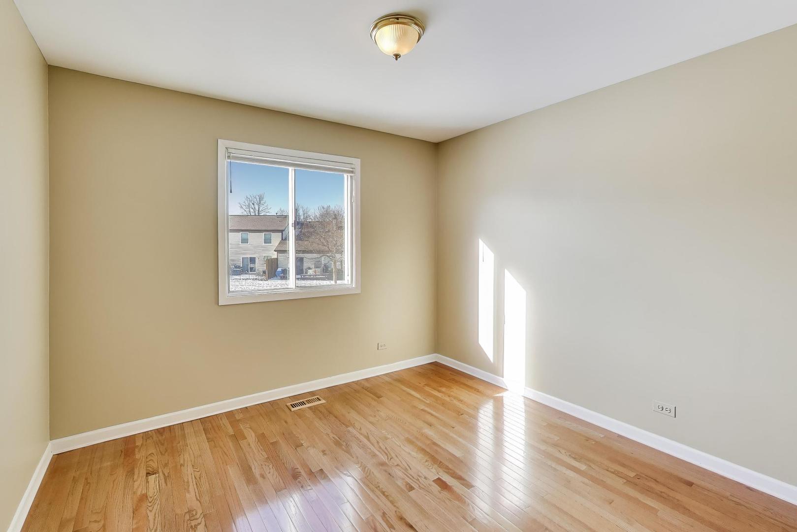N700 Concord Lane Winfield, IL 60190 - Photo 14 of 31 an empty room with wooden floor and windows