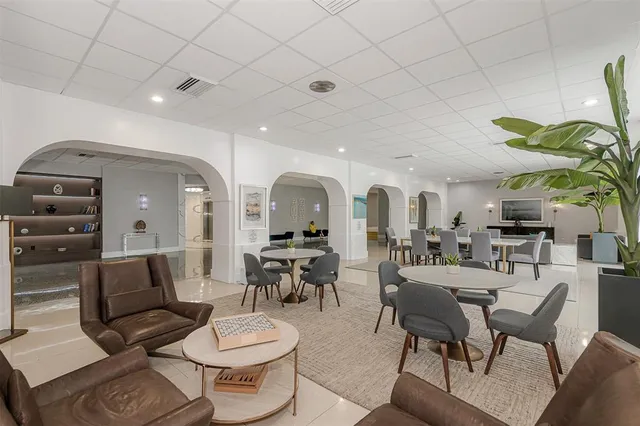 a living room with furniture a rug and white walls