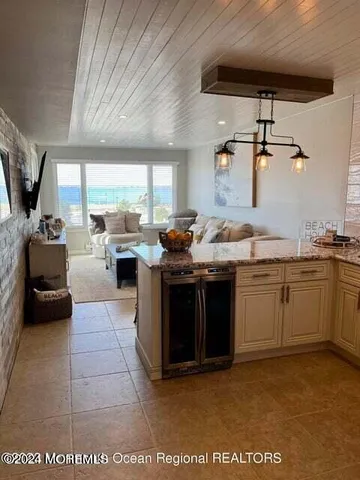 a large kitchen with stainless steel appliances and a refrigerator