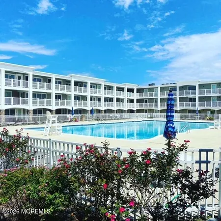 a view of a house with swimming pool and sitting area