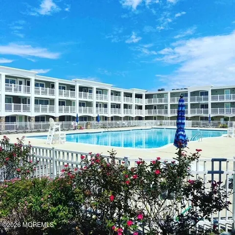 a view of a house with swimming pool and sitting area