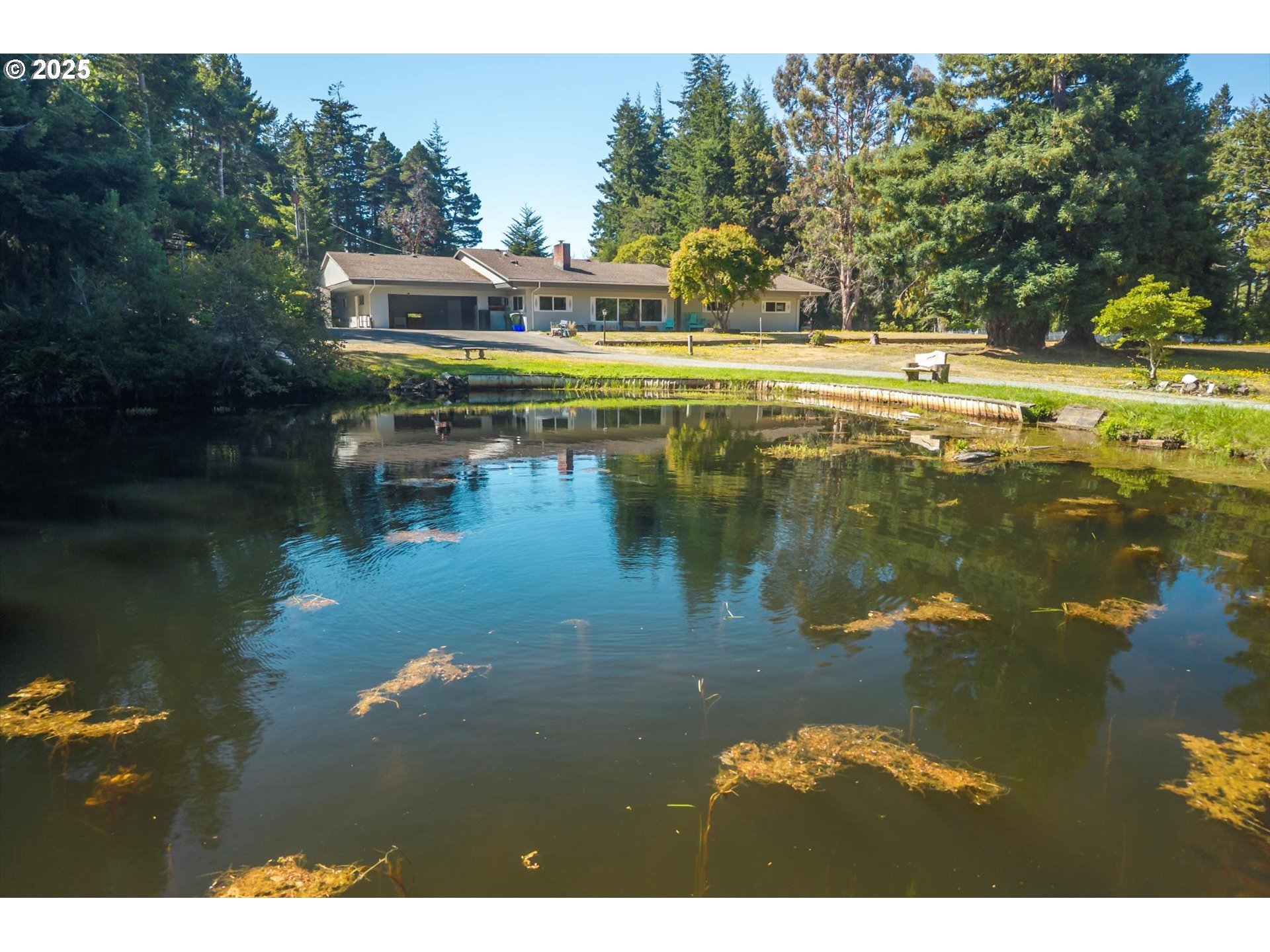 a view of residential house with outdoor space and lake
