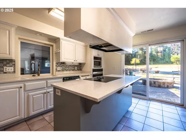 a kitchen with a sink and large window