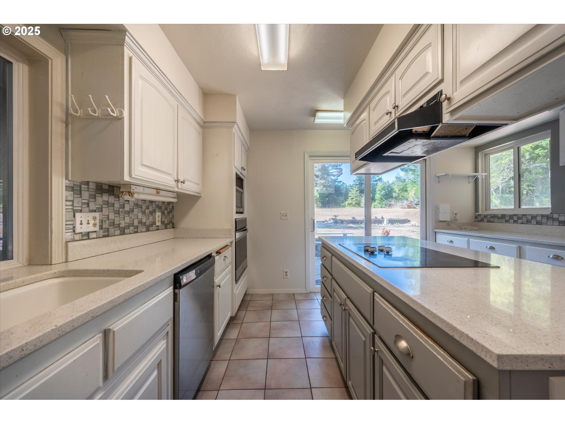 56060 Wheeler Road Bandon, OR 97411 - Photo 15 of 43 a kitchen with a sink and large window