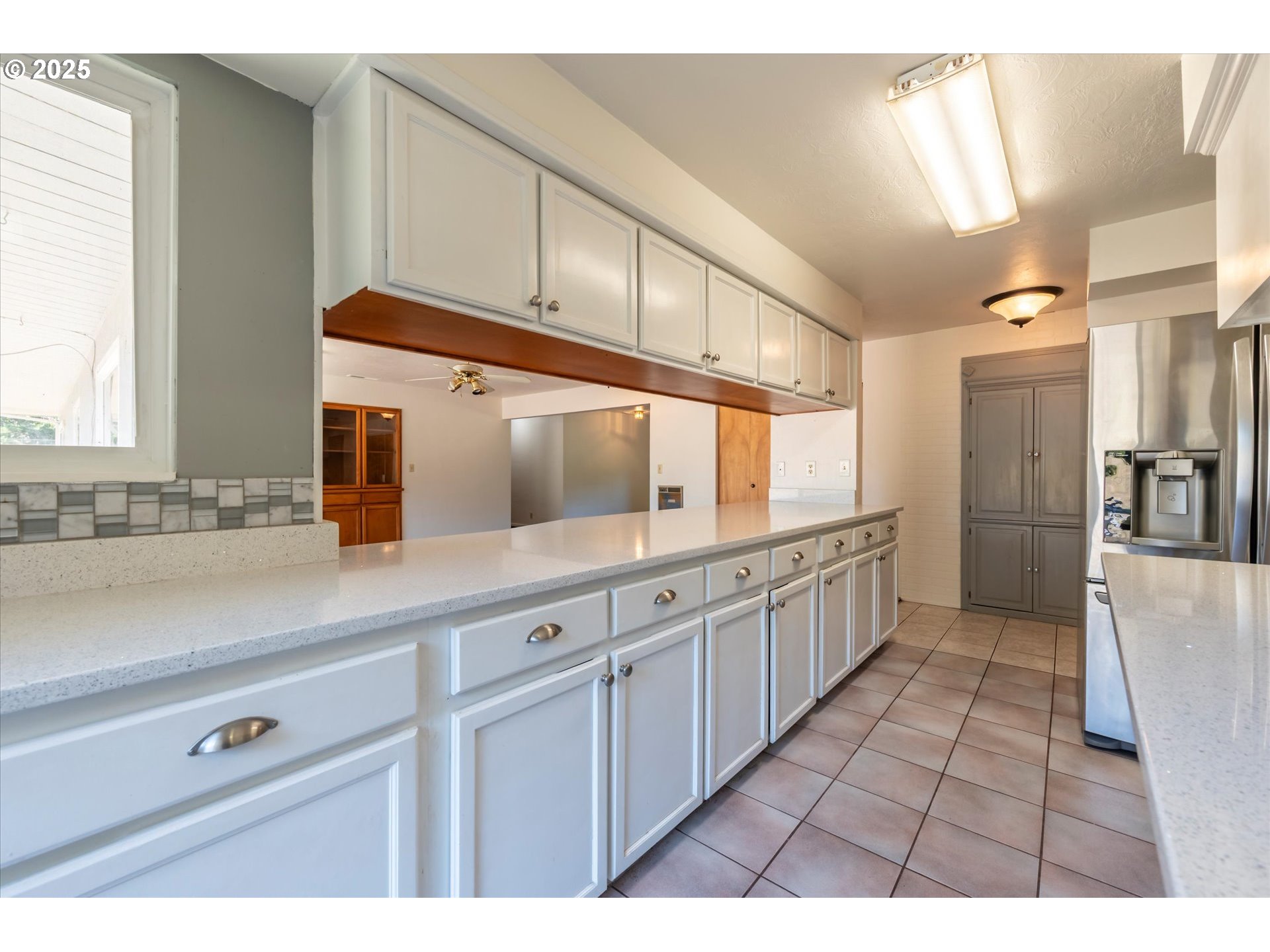 56060 Wheeler Road Bandon, OR 97411 - Photo 16 of 43 a large white kitchen with granite countertop a sink