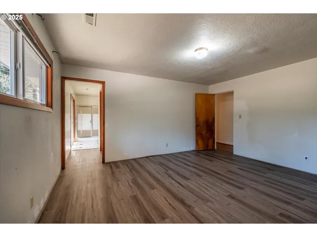 a bathroom with a sink a toilet a large mirror and shower