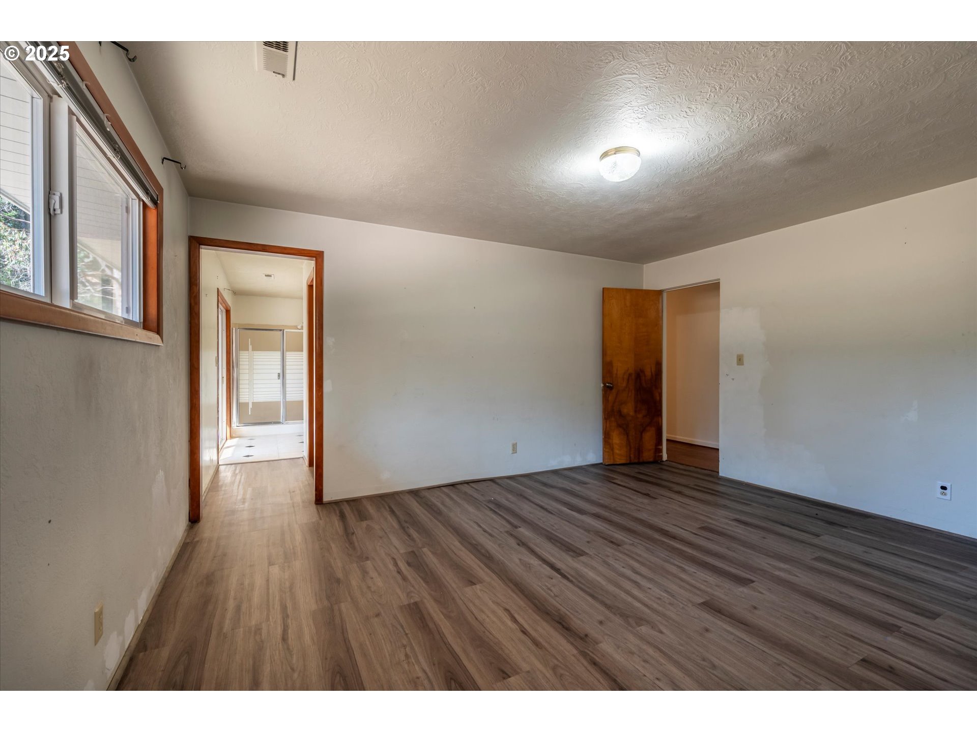 56060 Wheeler Road Bandon, OR 97411 - Photo 17 of 43 a view of an empty room with wooden floor