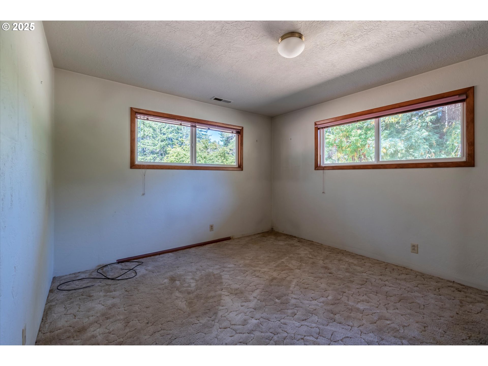 56060 Wheeler Road Bandon, OR 97411 - Photo 21 of 43 an empty room with a window