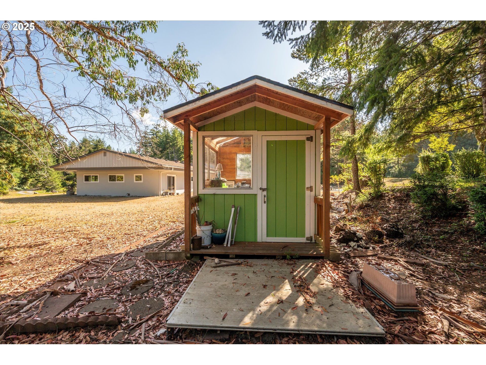 56060 Wheeler Road Bandon, OR 97411 - Photo 34 of 43 a view of a house with a yard