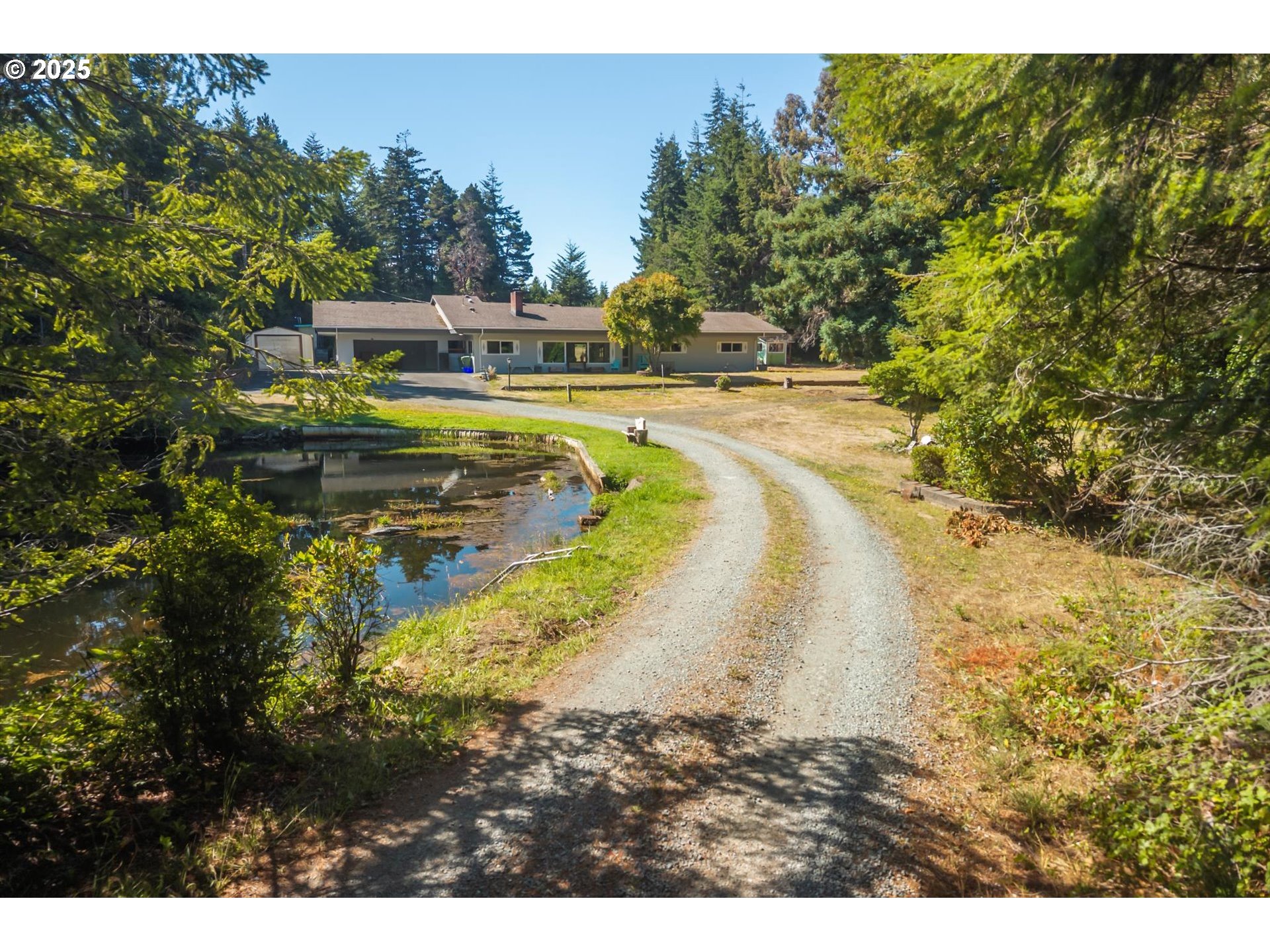 56060 Wheeler Road Bandon, OR 97411 - Photo 5 of 43 a view of a swimming pool with a yard