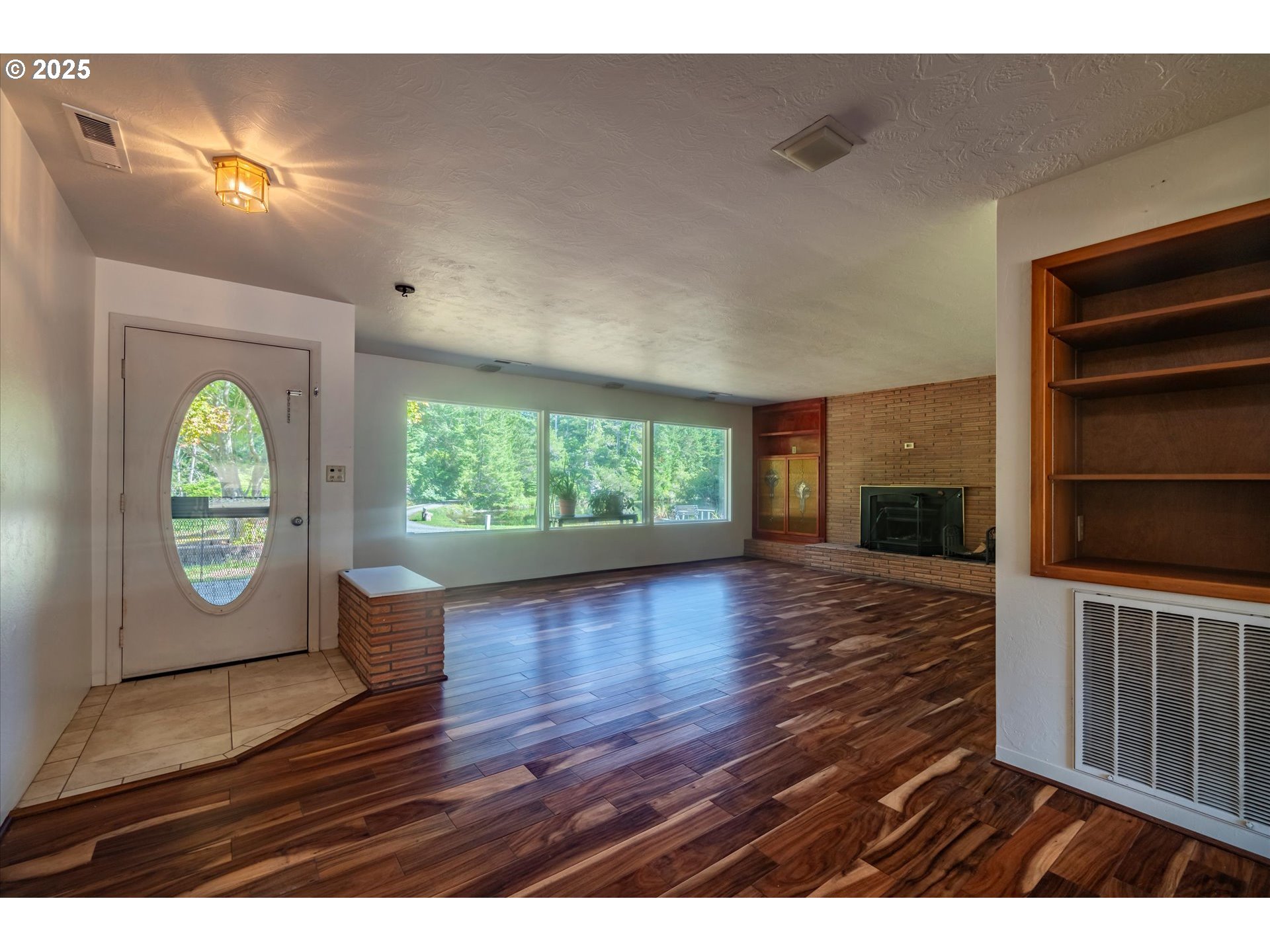 56060 Wheeler Road Bandon, OR 97411 - Photo 7 of 43 a view of empty room with wooden floor and fan