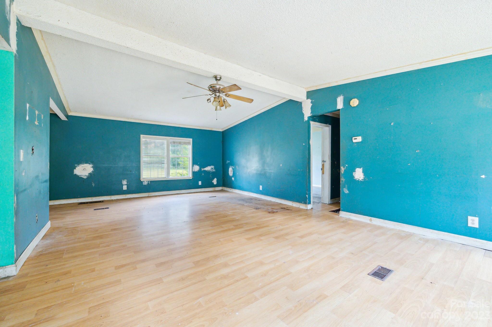520 Wright Road Vass, NC 28394 - Photo 6 of 23 a view of an empty room with window and wooden floor