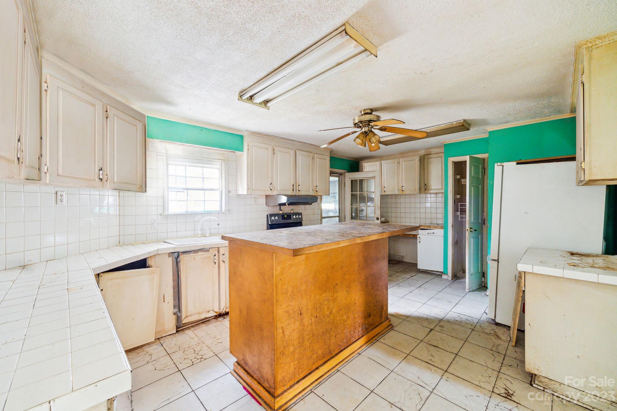 520 Wright Road Vass, NC 28394 - Photo 7 of 23 a kitchen with stainless steel appliances granite countertop a stove a sink a refrigerator and cabinets