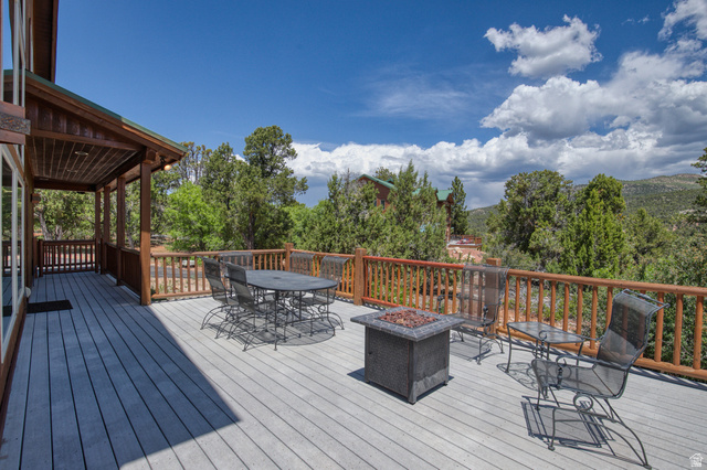 755 South Zion Ridge Drive Orderville, UT 84758 - Photo 20 of 84 Wooden deck with outdoor dining space and a fire pit