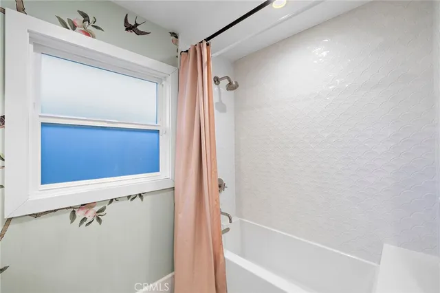 a bathroom with a double vanity sink mirror double and shower