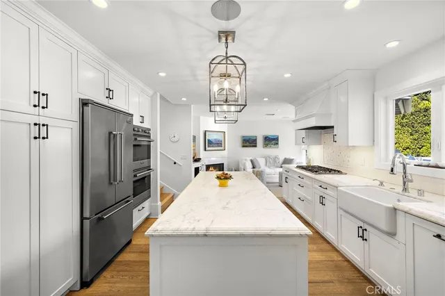 a large kitchen with sink and refrigerator