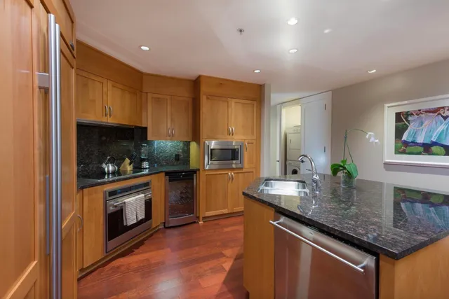 a bathroom with a tub a sink and mirror