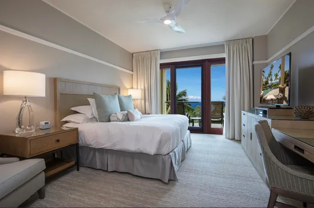 a bedroom with a large bed and a couch