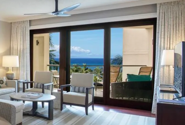 a living room with furniture a large window and a fireplace