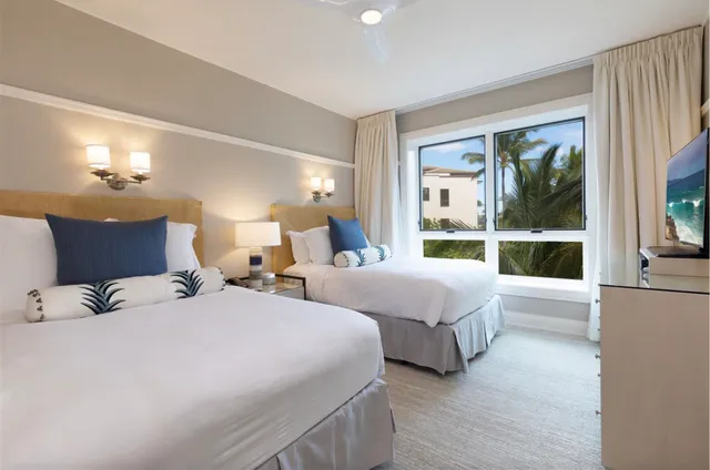 a spacious bathroom with a granite countertop double vanity sink a mirror and a shower