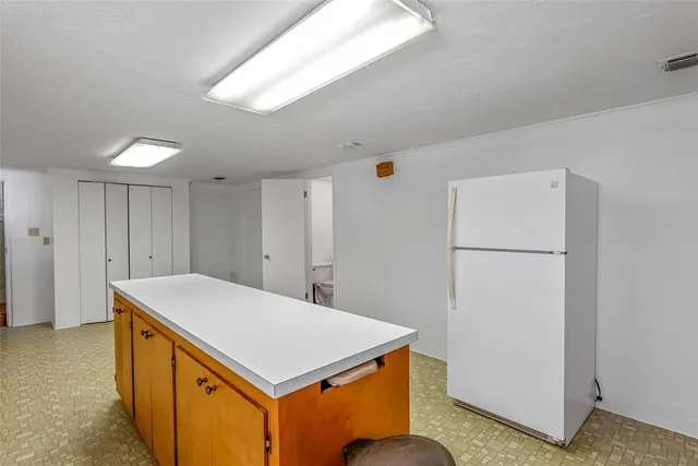 a kitchen with a refrigerator a stove top oven and a refrigerator