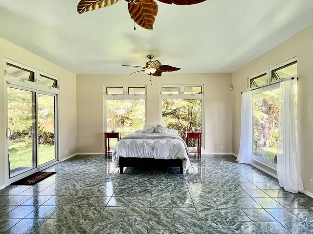 a bed room with a bed and a large window