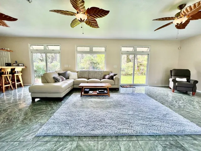 a kitchen with a dining table chairs and refrigerator
