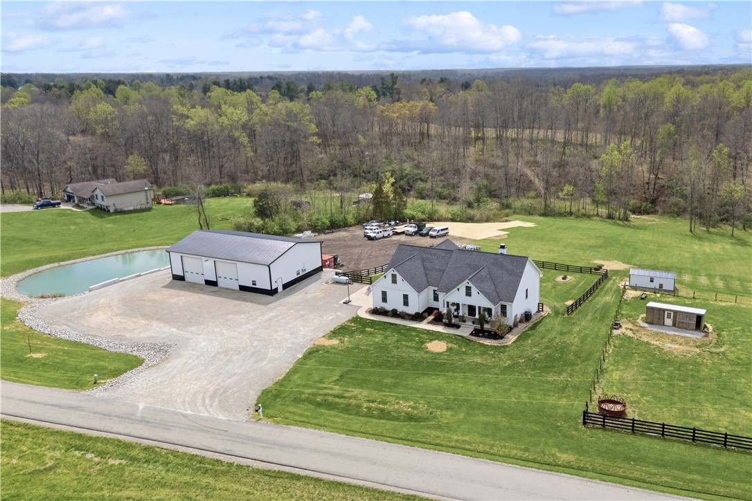 1158 Pyle Road Clarksville, OH 45113 - Photo 8 of 76 This expansive estate offers a beautiful residence alongside practical outbuildings and a serene pond.