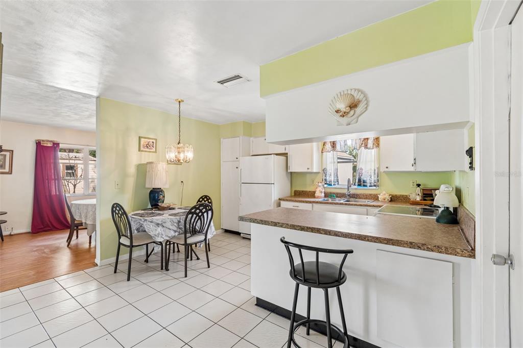 2059 Waterfall Drive Spring Hill, FL 34608 - Photo 6 of 26 a kitchen with a dining table chairs and white appliances
