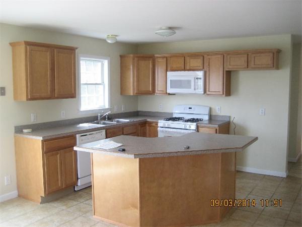 918 Jefferson Street Fall River, MA 02721 - Photo 2 of 6 a kitchen with stainless steel appliances granite countertop a sink stove and cabinets